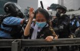 A protester reacts as she tackled by riot police during a massive demonstration outside the Legislative Council in Hong Kong, Wednesday, June 12, 2019. Hong Kong police have used tear gas and high-pressure hoses against thousands of protesters opposing a highly controversial extradition bill outside government headquarters. (AP Photo/Kin Cheung)